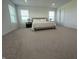 Spacious primary bedroom with ample natural light, neutral carpeting and views from multiple windows at 1256 Little Rodeo Pl, Greenwood, IN 46143