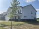 This well-manicured two-story home features sleek vinyl siding, brick foundation, and a spacious front yard at 1256 Little Rodeo Pl, Greenwood, IN 46143