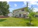 Lush backyard with an inviting deck, perfect for gatherings and enjoying the outdoors with string lights at 1260 Easton Point Dr, Greenwood, IN 46142
