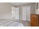 A well-lit bedroom features neutral walls, closet space, and an open doorway to the upper level at 1260 Easton Point Dr, Greenwood, IN 46142
