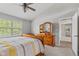 Bedroom featuring a dresser with tri-fold mirror and a window view to the outside at 1260 Easton Point Dr, Greenwood, IN 46142