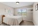 Bright bedroom filled with natural light, showcasing a comfy bed, window, and decorative shelves at 1260 Easton Point Dr, Greenwood, IN 46142
