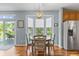 Cozy dining area with bay windows, hardwood floors, and stainless steel refrigerator in view at 1260 Easton Point Dr, Greenwood, IN 46142
