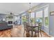 Bright dining area with hardwood floors, modern light fixture, and large windows overlooking the backyard at 1260 Easton Point Dr, Greenwood, IN 46142