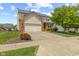 Charming two-story home with a well-manicured lawn, brick accents, and an attached two-car garage at 1260 Easton Point Dr, Greenwood, IN 46142