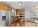 Open kitchen with stainless steel appliances, wooden cabinets, and a center island with seating at 1260 Easton Point Dr, Greenwood, IN 46142