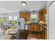 Open kitchen with stainless steel appliances, wooden cabinets, and a dining area with natural light at 1260 Easton Point Dr, Greenwood, IN 46142