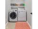 Functional laundry room with modern washer and dryer, complemented by storage shelves and a stylish rug at 1260 Easton Point Dr, Greenwood, IN 46142