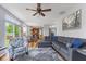 Open-concept living room with hardwood floors, ceiling fan, and view of the kitchen and dining area at 1260 Easton Point Dr, Greenwood, IN 46142