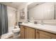 Bathroom with a shower-tub combo, toilet, vanity with sink, and a large mirror above the sink at 12922 St Andrews Way, Fishers, IN 46038
