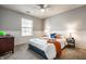 Bright bedroom with a queen bed, two side tables, lamps, and a window offering natural light at 12922 St Andrews Way, Fishers, IN 46038