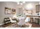 Cozy dining area with a modern round table, stylish chairs, and decorative wall art, near the kitchen at 12922 St Andrews Way, Fishers, IN 46038