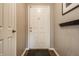 View of the home's entryway with a neutral color scheme and coat rack at 12922 St Andrews Way, Fishers, IN 46038