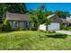 Well-kept single-story home with a brick facade, two car garage, green lawn and shade tree in the front yard at 12922 St Andrews Way, Fishers, IN 46038