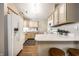 Well-lit kitchen with light wood cabinets, white countertops, and a breakfast bar with stools at 12922 St Andrews Way, Fishers, IN 46038