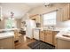 Spacious kitchen with light wood cabinets, white appliances, and a view into the dining area at 12922 St Andrews Way, Fishers, IN 46038