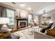 Comfortable living room showcasing a fireplace, neutral walls, stylish decor, and an open floor plan at 12922 St Andrews Way, Fishers, IN 46038