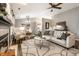 Spacious living room with vaulted ceilings, a fireplace, comfortable seating, and an open layout to the dining area at 12922 St Andrews Way, Fishers, IN 46038