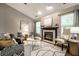 Inviting living room with a fireplace, light-colored walls, trendy furniture and a ceiling fan at 12922 St Andrews Way, Fishers, IN 46038