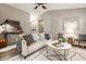 Open-concept living room features a ceiling fan, stylish furnishings, and a view of the dining area at 12922 St Andrews Way, Fishers, IN 46038