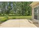Outdoor patio with tan siding, manicured lawn and mature trees providing shade and tranquility at 13172 Duval Dr, Fishers, IN 46037