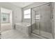 Bright bathroom featuring a soaking tub and separate glass-enclosed shower at 13172 Duval Dr, Fishers, IN 46037