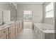 Spacious bathroom with a tub, dual sinks, tiled floor, and neutral paint throughout at 13172 Duval Dr, Fishers, IN 46037