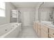 Luxurious bathroom with a soaking tub, tiled floors, and dual vanities for added convenience at 13172 Duval Dr, Fishers, IN 46037