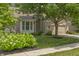 Inviting brick home with lush landscaping, a mature tree in front, and a convenient two-car garage at 13172 Duval Dr, Fishers, IN 46037