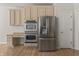 Bright kitchen features stainless steel appliances and tan cabinetry at 13172 Duval Dr, Fishers, IN 46037