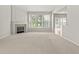 Spacious, bright living room with fireplace, large windows, and neutral carpeting at 13172 Duval Dr, Fishers, IN 46037