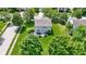 Aerial view of the home with a patio, a firepit, luscious green grass and mature trees at 14754 Drayton Dr, Noblesville, IN 46062