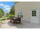 A covered dining set sits on a wooden back deck with a door to the home at 14754 Drayton Dr, Noblesville, IN 46062