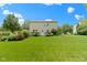 A lush green lawn extends from the house, with a wooden deck and garden at 14754 Drayton Dr, Noblesville, IN 46062