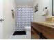 Modern bathroom featuring vanity with granite counters and a shower with geometric patterned curtain at 14754 Drayton Dr, Noblesville, IN 46062