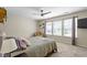 Bright bedroom with carpeted floors, ceiling fan, and natural light from the large window at 14754 Drayton Dr, Noblesville, IN 46062