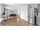 Open concept dining room with wood floors and stainless steel fridge at 14754 Drayton Dr, Noblesville, IN 46062