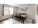 Stylish dining room with a large wooden table, seating for eight, modern lighting, and a decorative area rug at 14754 Drayton Dr, Noblesville, IN 46062