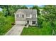 Inviting two-story home featuring a combination brick and vinyl facade, a front porch, and a two-car garage at 14754 Drayton Dr, Noblesville, IN 46062