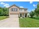 Charming two-story home with a brick and vinyl exterior, attached garage, front porch, and well-maintained lawn at 14754 Drayton Dr, Noblesville, IN 46062