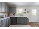 The kitchen features modern gray cabinets, granite countertops, and stainless steel appliances at 14754 Drayton Dr, Noblesville, IN 46062