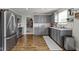 Modern kitchen featuring stainless steel appliances, gray cabinets and granite countertops at 14754 Drayton Dr, Noblesville, IN 46062