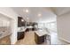 Modern kitchen with dark cabinets, stainless steel appliances, a center island, and an adjoining dining area at 1550 Fox Hollow Dr, Martinsville, IN 46151