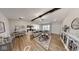 Inviting living room featuring wood floors, a ceiling fan, comfortable seating, and an open view to the kitchen at 1550 Fox Hollow Dr, Martinsville, IN 46151