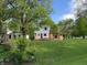 Spacious backyard featuring a large lawn, mature trees, and a custom wooden deck perfect for outdoor entertaining at 1738 E 71St St, Indianapolis, IN 46220