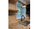 Kitchen sink with granite countertops, stone backsplash, and bright window at 1738 E 71St St, Indianapolis, IN 46220