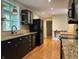 Modern kitchen with black appliances, wooden floors, granite counters and lots of natural light at 1738 E 71St St, Indianapolis, IN 46220