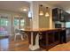 Open concept kitchen with a dining area and wooden table with granite countertops, and modern appliances at 1738 E 71St St, Indianapolis, IN 46220