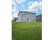 Spacious backyard featuring lush green grass and a view of the home's rear exterior at 1932 Downey Ln, Greenfield, IN 46140