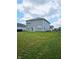 Expansive green backyard showcasing the home's exterior, perfect for outdoor activities at 1932 Downey Ln, Greenfield, IN 46140